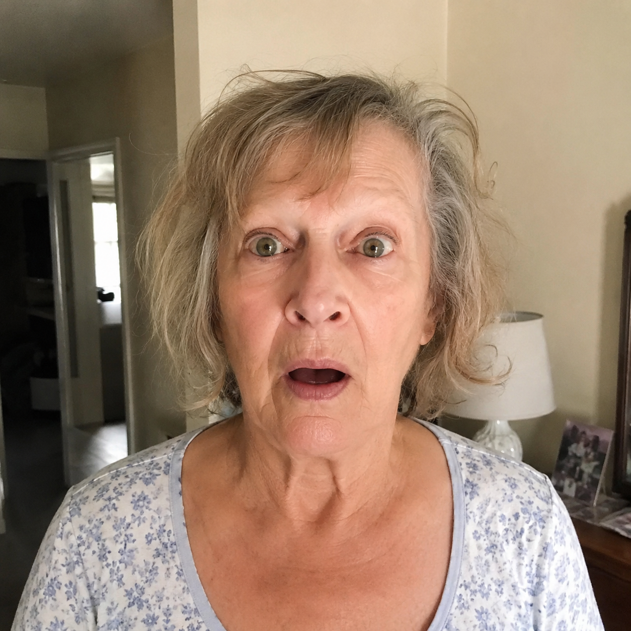 Elderly woman with a shocked expression, messy hair, before style photo.